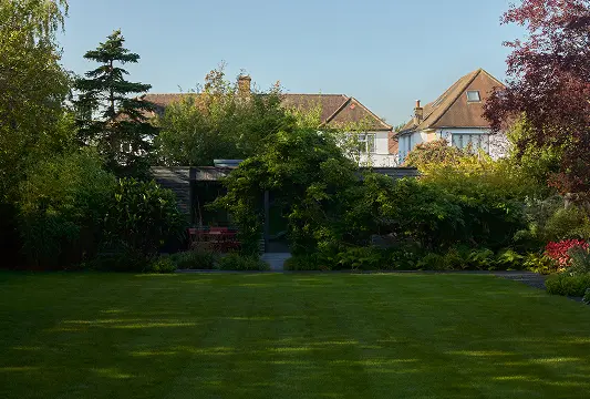 Garden house at the end of a landscaped lawn